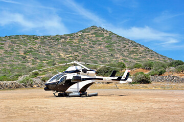  A small  helicopter stands in a ground parking, Elounda, Crete, Greece