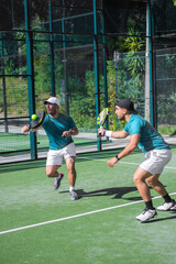Two padel players. Energetic padel game moment ideal for social media posts and sports ads