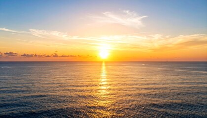Obraz premium A bright sun shining over the ocean water during an orange and blue sunset