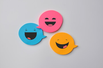 colorful speech bubbles with smiles, a concept of fun communication and correspondence