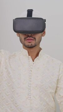 Vertical Video of Muslim Man Zooming and Using Vertual Computer Through VR Headset