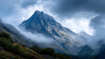 "Majestic Mountain Peak Shrouded in Clouds"