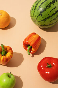 Bright pop art style fruits and vegetables on a beige surface