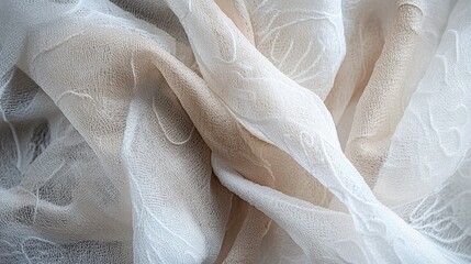 Delicate, patterned sheer fabric in cream and beige tones.