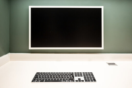 Minimalist workspace with wall-mounted monitor and keyboard
