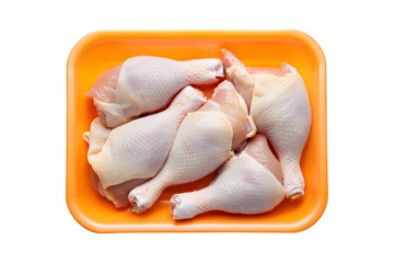 Raw Chicken Drumsticks Packed in Orange Tray on meat poultry