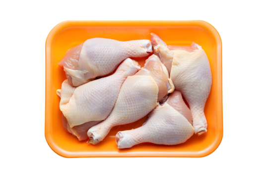 Raw Chicken Drumsticks Packed in Orange Tray on meat poultry