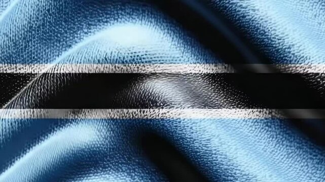 The flag of Botswana gracefully drapes, showcasing its blue, black, and white colors in intricate detail and texture, representing the nation&rsquo;s pride.