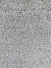 Close-up of a light gray stucco wall with natural texture. Ideal as a clean background or template for minimalist design projects, presentations, or web design
