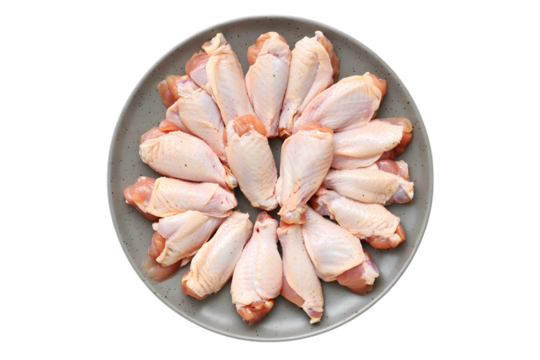 Raw chicken wings arranged in a circular pattern on a speckled gray plate poultry meat