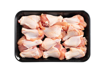 Raw chicken wings packed in plastic tray against poultry meat