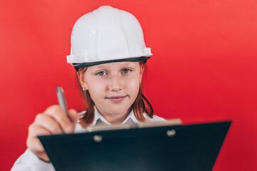 Child Engineer in White Hard Hat Writing on Clipboard Future Career Concept