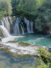 A cascading waterfall in a rocky forest