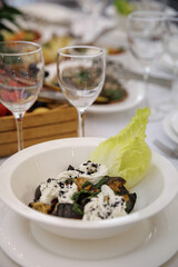 A beautifully arranged table with vibrant flowers and a selection of fresh fruits accompanied by...