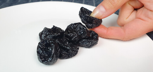 Dried prunes on a plate. Natural prune fruit, a nutritious ingredient