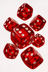 Red transparent dice with white dots flying in midair on white background. Symbol of luck, risk, gambling, and chance. Studio close-up shot.