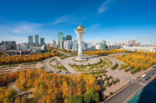 Astana, Kazakhstan, 10 October 2024: Baiterek monument with street, cars and city buildings in autumn