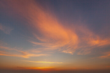 Beautiful sunset painting the sky with hues of orange and pink over a serene horizon at dusk
