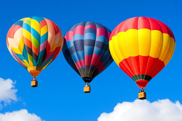 Naklejka premium Colorful hot air balloons floating in a bright blue sky