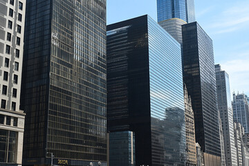 Fototapeta premium Reflection of modern office buildings in glass facade
