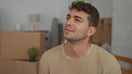 Man touches face while smiling in home where young hispanic remembers moving boxes and guy imagines...
