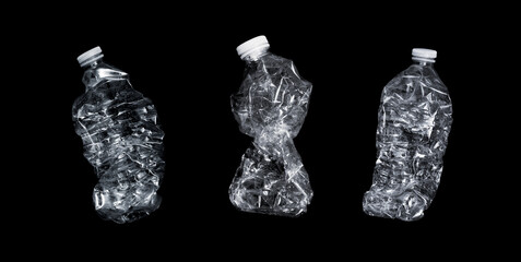 3 flattened water bottles on black background - garbage concept