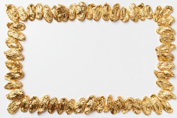 Obraz premium Gold nuggets frame on a white background, financial concept with copy space