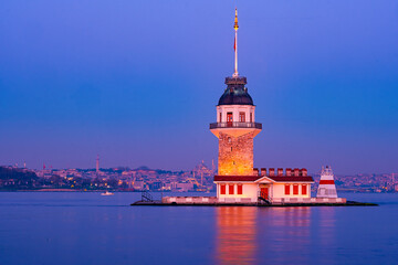 iery sunset over Bosphorus with famous Maiden's Tower (Kiz Kulesi) also known as Leander's Tower, symbol of Istanbul, Turkey. Scenic travel background for wallpaper or guide book