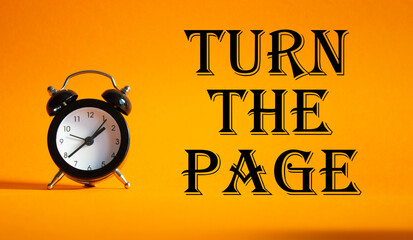 Turn the Page symbol. Concept words Turn the Page on Beautiful orange background with alarm clock....