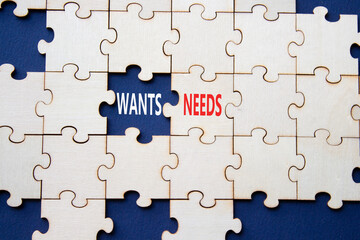 Fototapeta premium Wants and Needs symbol. Concept word Wants and Needs on wooden blocks. Beautiful deep blue background. Business and Wants and Needs concept. Copy space