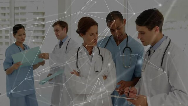 Nurse handing patient file to doctor and senior doctor pointing tablet, network lines linking team