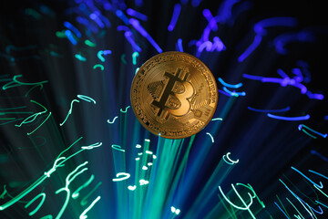 Bitcoin and Cryptocurrency Exchange Concept with Fiber Optic Lights and Digital Coin on Dark...