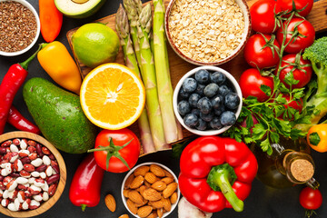 Healthy food assortment on black background.