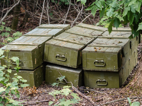stack of wooden ammunition boxes in the forest