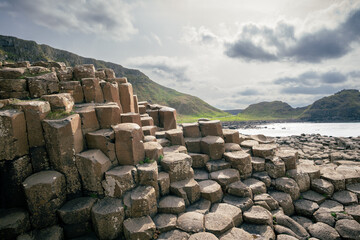 Giant’s Causeway at Golden Hour with Ocean and Distant Mountains – Northern Ireland Landscape