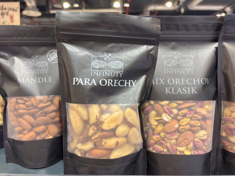 Bratislava, Slovakia, Europe - Jul 03, 2025: several black pouches of Infinuty nuts, including mandle, almonds, para orechy, brazil nuts, and mix orechov, classic mix
