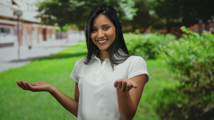Young woman smiling in a park setting, showcasing an inviting and lively outdoor atmosphere with vibrant greenery under a clear sky.