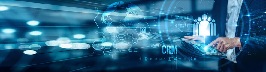 A businessman using a tablet is analyzing CRM data to improve customer relationships, streamline communication, increase retention, boost sales, and enhance overall customer service efficiency.