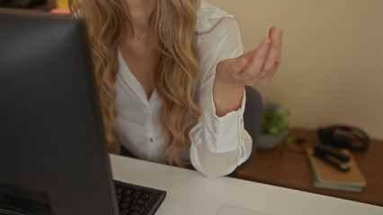Woman meditating at desk in office with computer relaxing stress relief calm focus workplace...