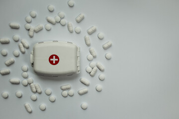 White horizontal background with space for text, white compact pill box with the symbol of the...