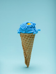 Blue bubble gum ice cream cone isolated on blue background
