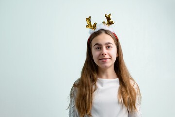 Cheerful girl reindeer antlers gray background showing different funny emotions, surprise, joy