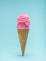 Double Scoop of Pink Ice Cream in a Waffle Cone. Blue background
