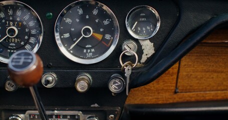 Close-up of the dashboard in a retro car. The key is in the ignition
