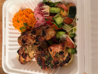 Grilled chicken with fresh salad and pickled vegetables in eco-friendly box