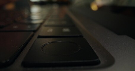 The man uses a laptop. Close-up of his finger on the reset button. An unrecognizable person