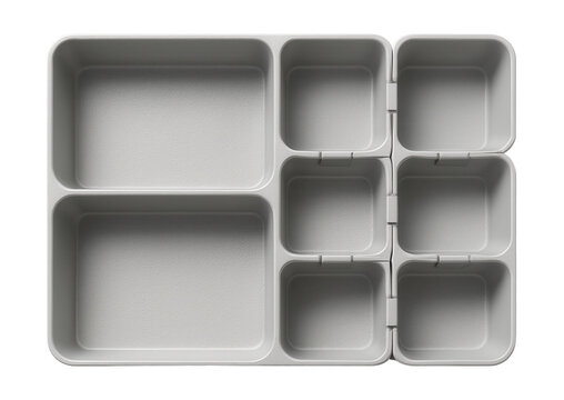 Textured plastic drawer organizer with interlocking pieces, designed for a craft room to sort beads and threads.