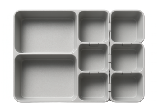 Textured plastic drawer organizer with interlocking pieces, designed for a craft room to sort beads and threads.
