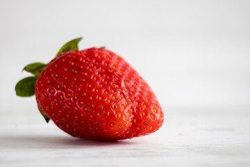 Fresh organic strawberries on a light background
