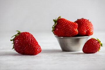  Fresh organic strawberries on a light background.